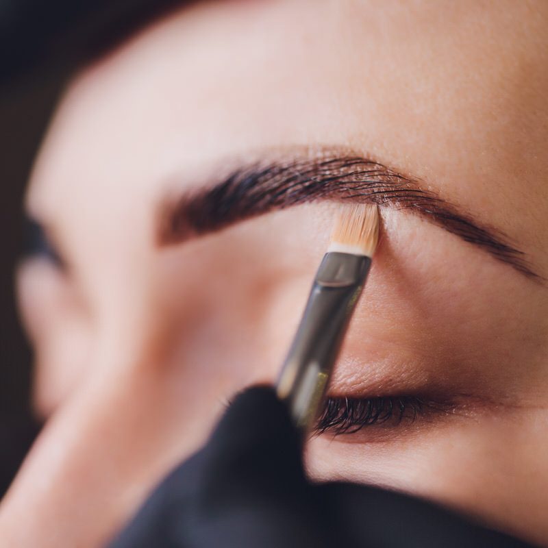 beautician-applies-henna-paint-trimmed-eyebrows-beauty-salon